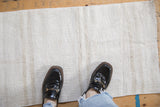 Overhead view showing the scale and textured plain-weave of a vintage hemp kilim mat.