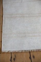 Close view of a vintage hemp kilim's textured plain weave and beige color abrash.