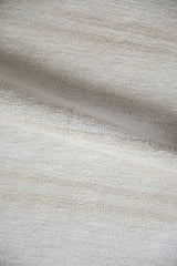 The natural abrashes and texture of the plain-weave on a hemp kilim rug.