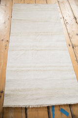 Vintage hemp kilim's plain weave showing soft ivory, platinum, beige abrashes and fringe.