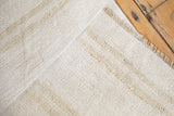 Plain-weave texture of the vintage hemp kilim rug with ivory, platinum, and beige patterned strips.