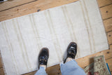 Vintage hemp kilim rug showing its soft plain-weave texture underfoot.