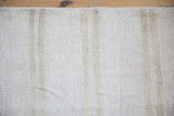 Nubby plain-weave texture of a hand-woven hemp kilim in ivory with beige abrash.