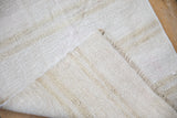 The plain-weave back and secure machine-bound side of a vintage hand-woven hemp kilim.