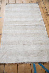 Plain-weave vintage hemp kilim fringe with ivory, platinum, and oxidized silver abrashes.