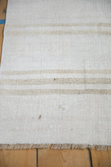 Vintage hemp kilim rug showcasing plain-weave, ivory, platinum, beige striped abrashes, and fringe.