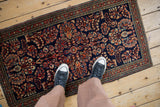 Vintage Sarouk runner's dense floral bouquets and arabesque border in cobalt blue, madder root red.
