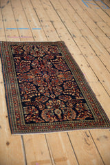 Sarouk rug's madder red floral bouquets on cobalt blue field, with arabesque border.