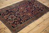 Vintage Sarouk rug runner featuring intricate floral bouquets, germinating plant borders, and wide arabesque motifs.