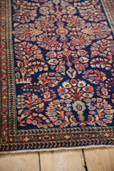 Vintage Persian Sarouk runner's intricate red and blue floral field, with borders and fringe.