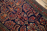 Intricate floral bouquets on a cobalt blue Sarouk rug, with a madder root red arabesque border.