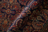 Sarouk rug's floral bouquets and arabesque border in cobalt blue and madder red.