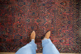 Antique Mohajeran Sarouk rug with dusty red field, sapphire blue floral sprays, arabesque palmette border.