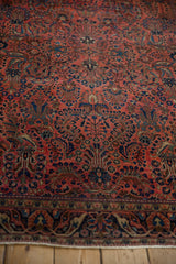 Antique Mohajeran Sarouk rug's dense floral arabesque and palmette design in dusty rose and blue.