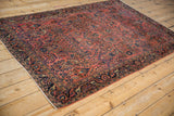 Antique Mohajeran Sarouk rug corner, with fluid navy arabesque border and floral field design.