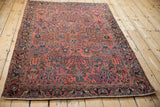 Antique Persian Mohajeran Sarouk rug corner, dusty red field and fluid navy palmette border.