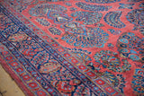 Hand-knotted vintage American Sarouk pile in brick red with sapphire blue palmettes and navy border.