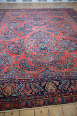 Persian American Sarouk carpet's brick red field with sapphire blue floral sprays and palmettes.