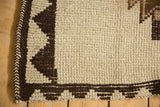 Hand-knotted Kurd rug's textured ivory and chocolate brown zig-zag border.