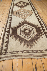 Geometric ivory and chocolate brown Kurd runner detail, showing visible knot heads.