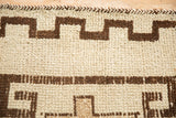 Vintage Kurd runner detail: ivory and brown geometric pattern, shorn pile, and braided selvage.