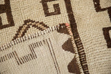 Vintage Kurd rug detail showing ivory and brown geometric pile, woven reverse, and tall selvage.