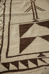 Geometric design elements on a vintage Kurd rug, showcasing ivory and dark brown knots.
