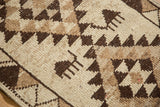 Hand-knotted texture of a Kurd rug showing primitive animal figures and a serrated triangle border.