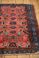 A vintage Lilihan rug's tattered corner showing the detailed sapphire blue floral main border.