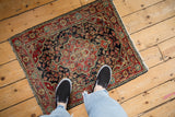A vintage Josan Sarouk rug mat shown on a wood floor for real-life size perspective.