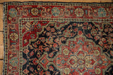 Intricate corner spandrel and floral borders of a hand-knotted vintage Persian Sarouk mat.