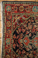 Detailed corner of a vintage Josan Sarouk rug showing intricate floral borders and hand-knotted pile.