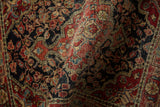 The dense, hand-knotted pile of a vintage Josan Sarouk revealed in a soft, curving fold.