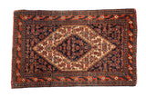 Vintage Senneh rug mat with a stepped diamond medallion, navy blue Herati field, and madder red borders.