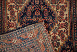 Intricate hand-knotted foundation and colorful wool pile of the vintage Senneh rug.
