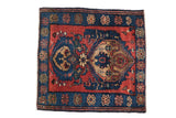 Antique Persian Malayer square rug with asymmetric double medallions on a madder red and sapphire blue field.