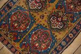 Detail of scrolling cloud-band motifs in cobalt blue and red on an antique Farahan Sarouk rug.