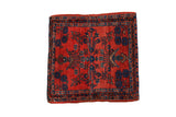 Antique German Sarouk square mat with a ruby red field, sapphire blue floral bouquets, and a triple border.