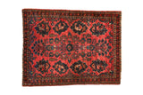 Vintage Sarouk square rug mat in raspberry red with a central floral spray and unique fish and chicken motifs.