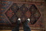 Hand-knotted Persian Mehreban rug with deep navy field, red and blue trefoil guls.