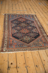 Vintage Mehreban rug corner: trefoil guls, red and navy spandrel animals, ivory fringe.