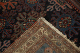 Vintage Mehreban rug showing hand-knotted foundation, geometric trefoil guls, navy, and red pile.