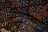 Vintage Persian Mehreban rug, highlighting textured trefoil guls in madder root red and navy blue.