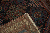 Vintage Mehreban rug corner, showing pile wear, foundation, and secured worn side.