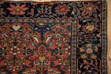 Navy blue main border with palmettes on an antique Farahan Sarouk rug's finely woven corner.