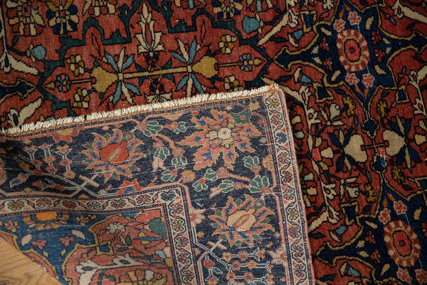 Corner of an antique Farahan Sarouk rug folded back to show the front pile and woven foundation.