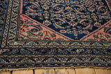 Ornate borders in cobalt blue, blush pink, and ivory on a vintage Lilihan rug end.