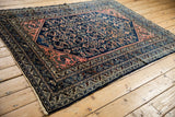 Vintage Lilihan rug end with worn fringe, displaying Herati pattern in cobalt, blush.