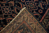 Vintage Lilihan rug corner folded, revealing hand-knotted back weave, fringe, and Herati motif.