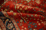 Dense, cherry red pile and traditional floral motifs on a hand-knotted Persian Sarouk rug.